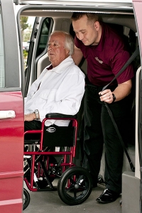 Stellar driver helping elderly patients into van, Melbourne transportation for seniors